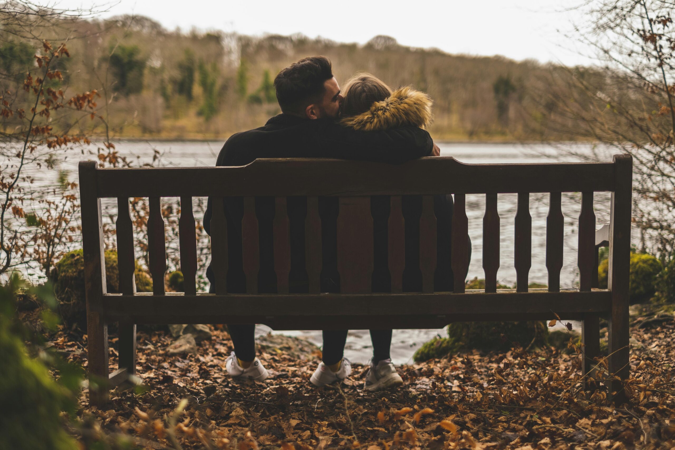 A couple sitting on a beach in a forest. The man is asking, 'What does it mean when someone says you smell good?