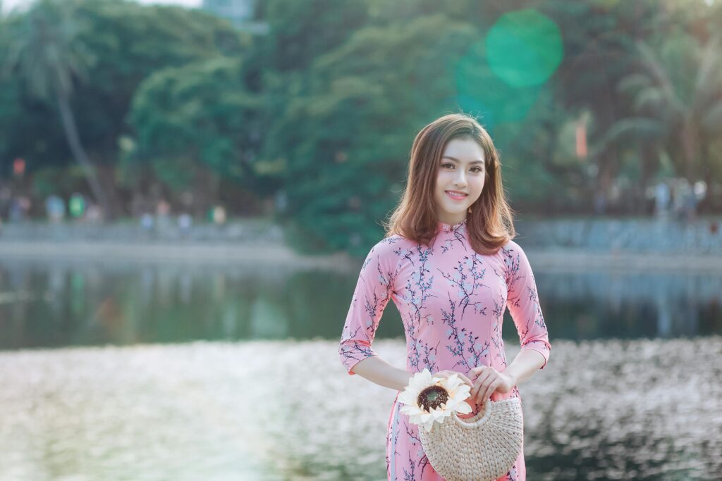 A beautiful girl standing along a canal, with someone commenting on her body odor.