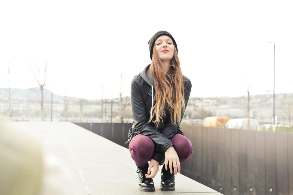 A girl sitting and looking at someone when he is not looking at her.