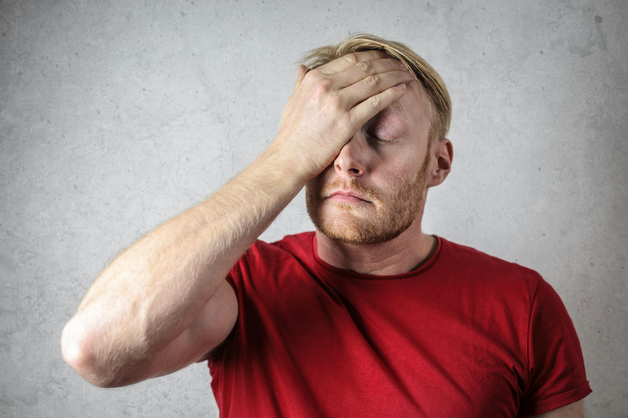 A man looking upset and deep in thought, pondering the meaning behind a guy apologizing for hurting you.