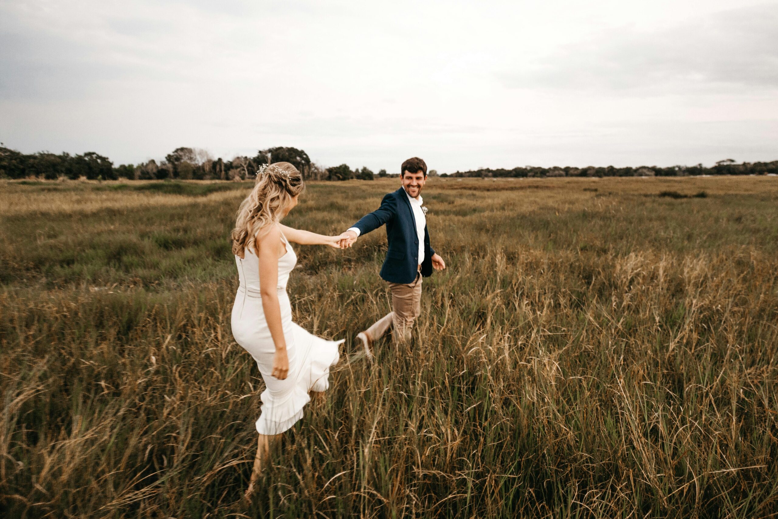 A young couple walking through fields, with the boy asking the girl, 'What are you wearing?