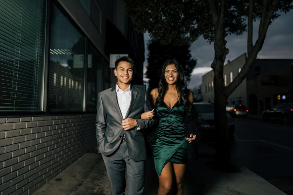 A couple coming back from a date, sharing smiles and possibly discussing their evening together.