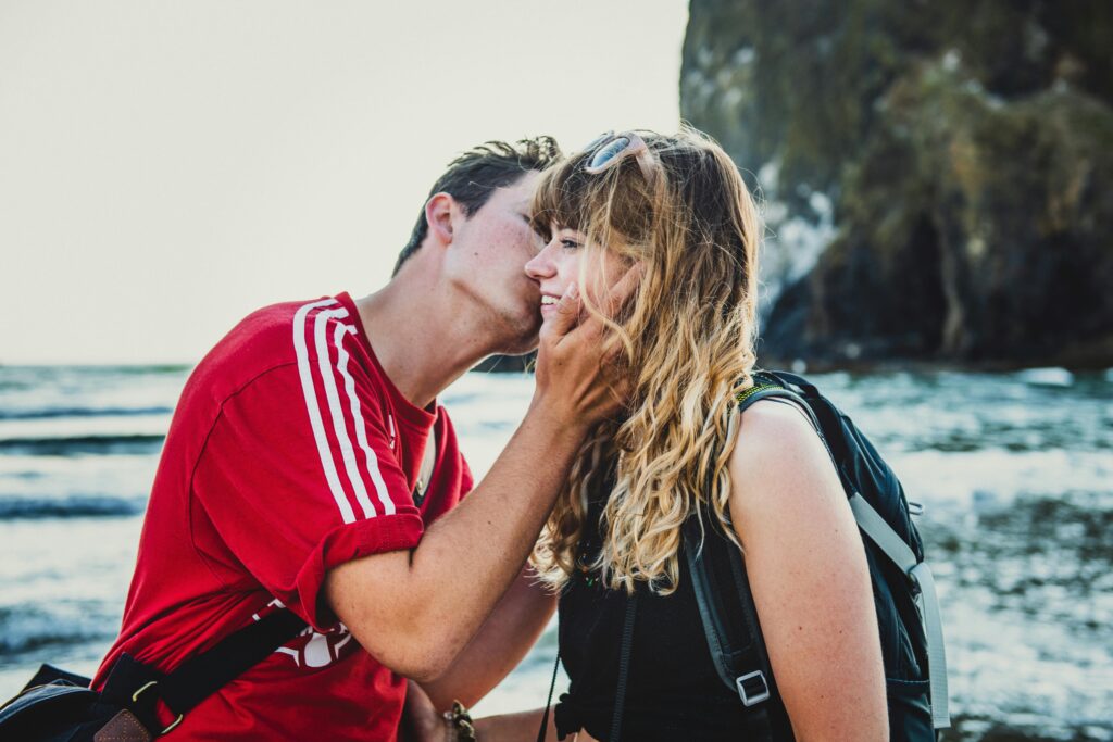 A couple enjoying themselves at the ocean, engaged in conversation.