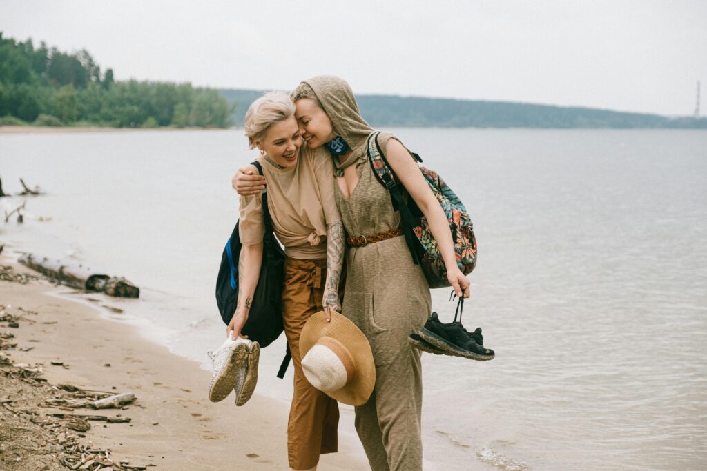 A couple smiling and enjoying themselves on the beach.