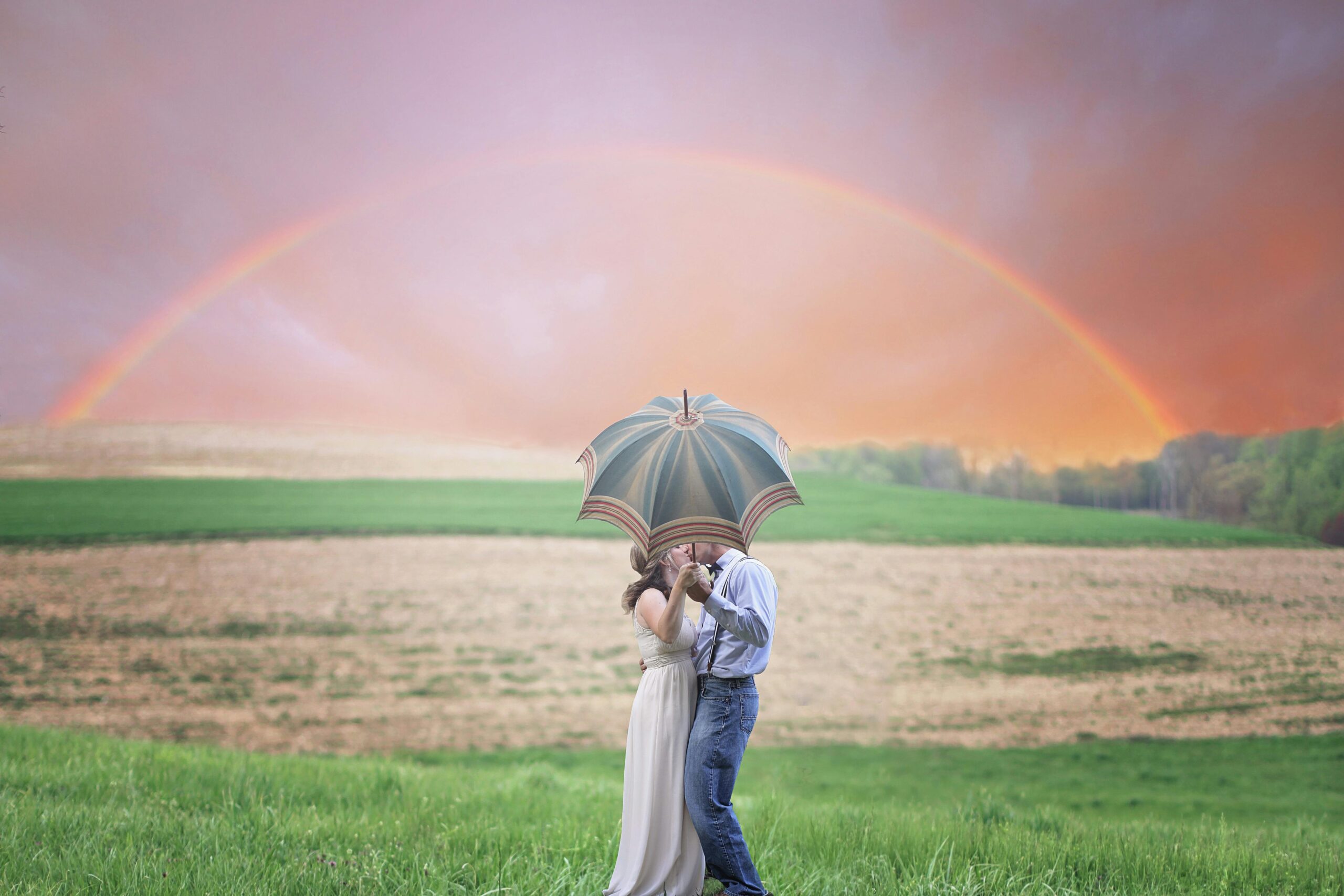 A couple enjoying a rainbow together, wondering what it means when a guy presses his forehead against yours.