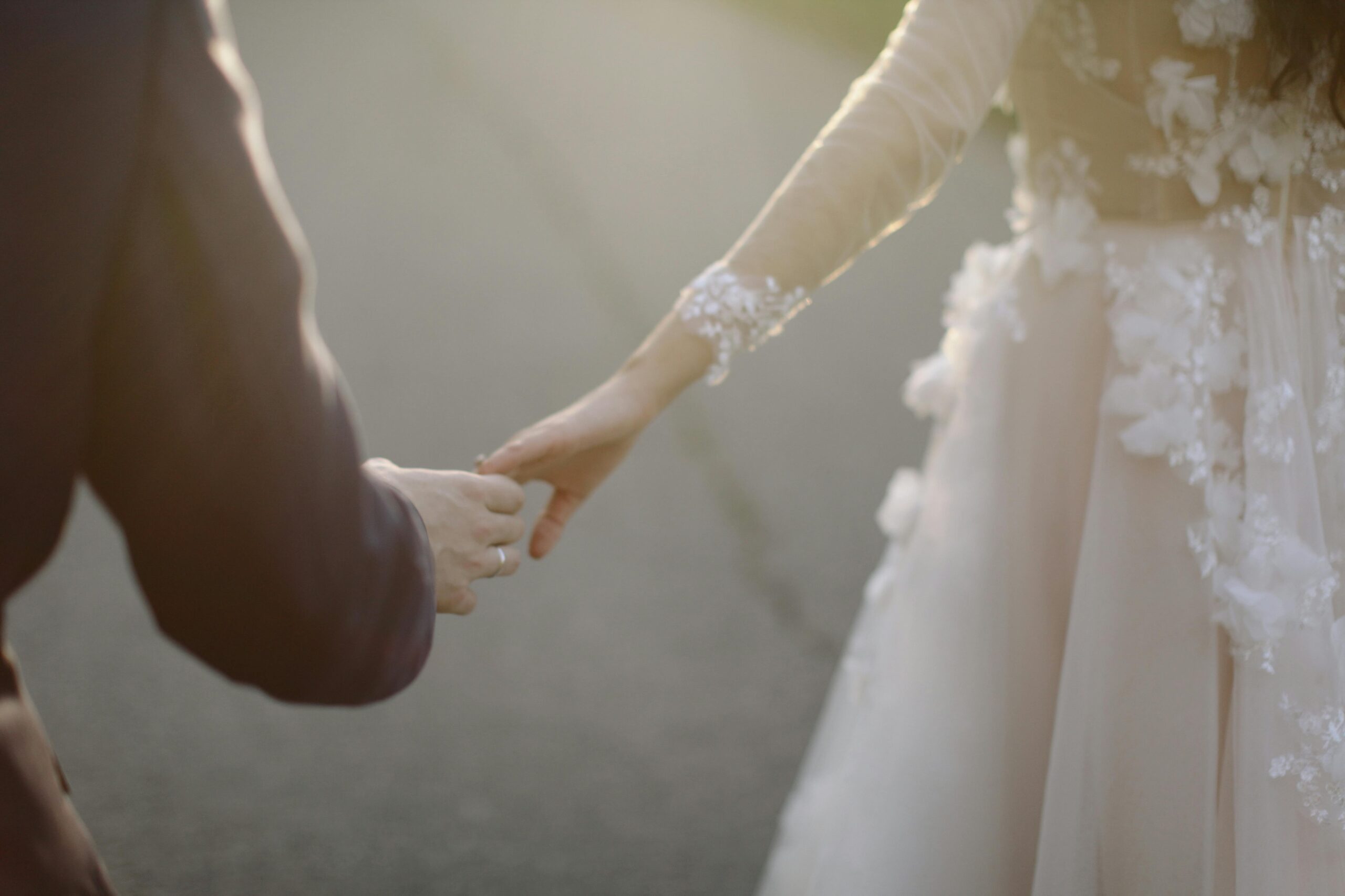 A scene of a bride and groom, with a boy holding his girlfriend's hand. Wondering what it means when a guy rubs your arm up and down.