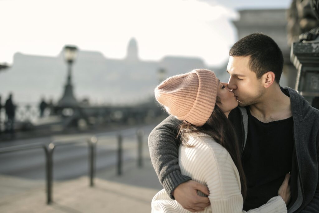 A couple expressing love and sharing kisses."