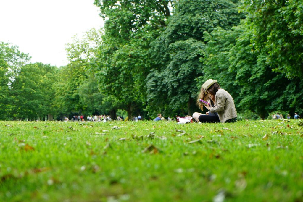 A couple sitting in a park, discussing why a boy is looking at the girl.